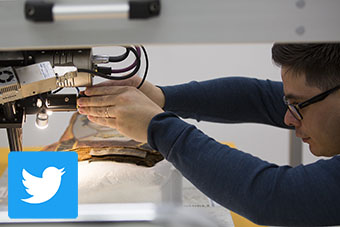 A conservation scientist at the Getty Conservation Institute analyzes a mummy portrait with x-ray fluorescence imaging; the Twitter logo is overlaid in the bottom left corner of the image.