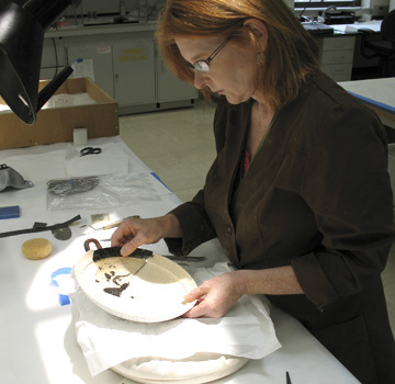Conservator Susan Lansing Maish positioning the fragments 
of the kylix