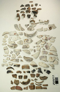 Fragments of the lekythos displayed on a table before conservation