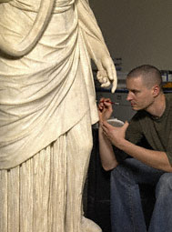 Conservator Erik Risser in-painting the Hope Hygieia