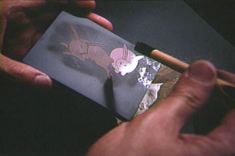A craftsman applies decoration to a lacquer object