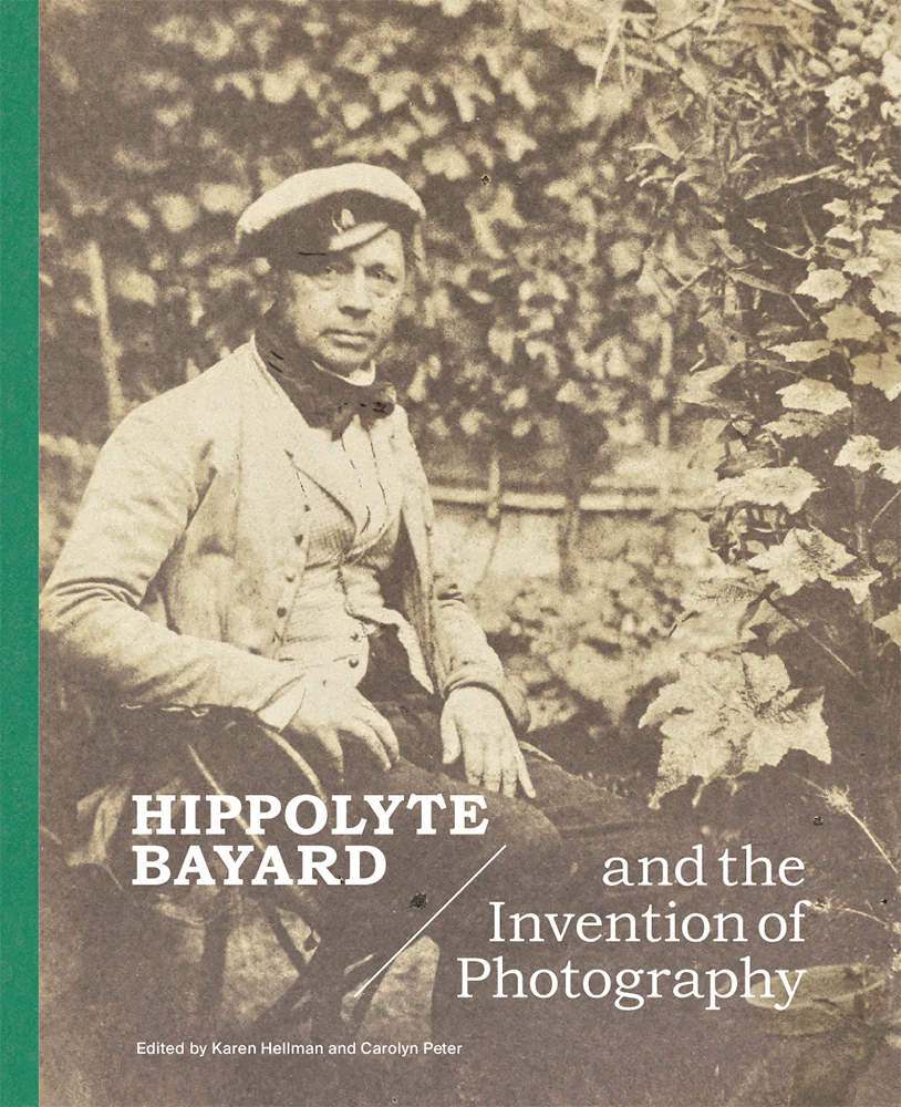 Book cover featuring a sepia toned photograph of a smartly dressed man sitting in a garden