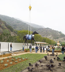 A crane lowers Elisabeth Frink's Horse