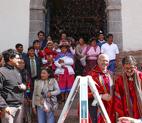 Getty staff and community members look out from the entrance of the Church of Kunotambo.