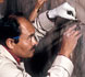 conservators filling plaster cracks
