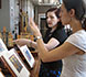 curatorial staff studying manuscript