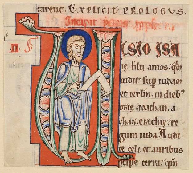 Full-length prophet wearing green and blue robes within a green initial with foliate ornament on a red background.
