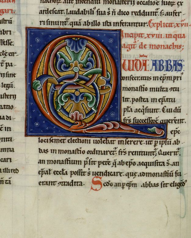 Red initial filled with burnished gold and blue-and-green foliate ornament within a blue background.