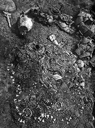 Grave 11 during excavation, showing jewelry and vessels