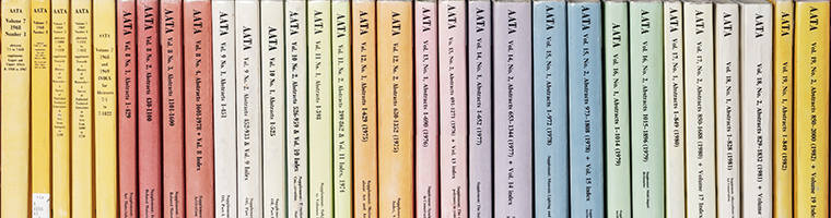Image of the spines of multiple volumes of the printed AATA publiation