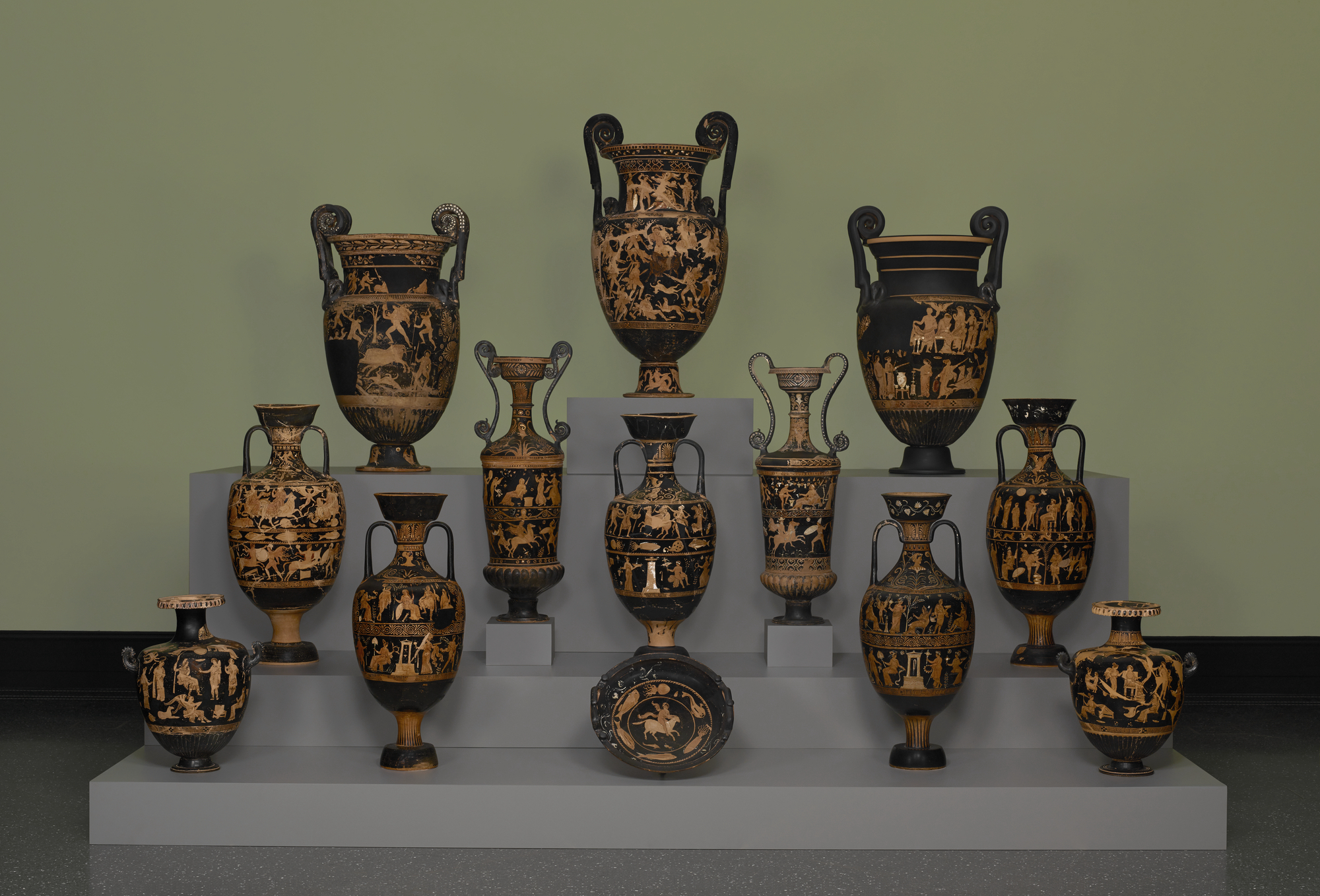 three tiers of ancient vases on display