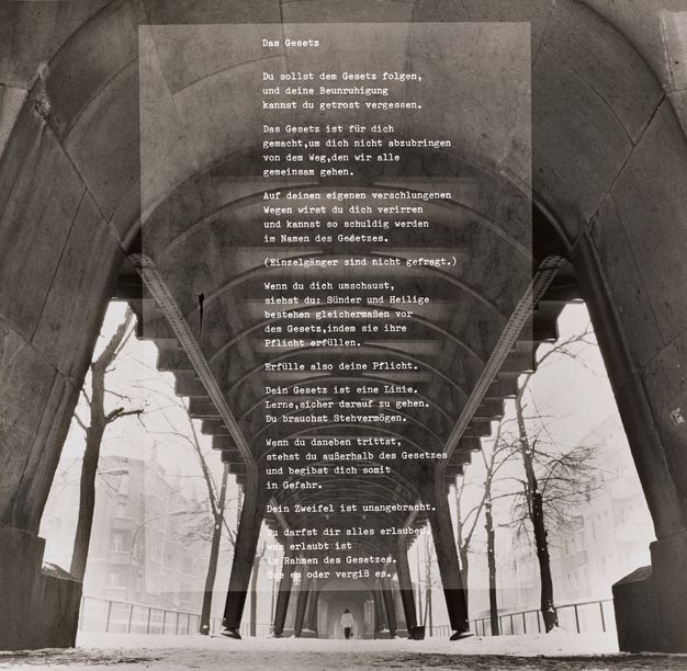 White typewriter font superimposed on a grayscale image taken beneath an arched subway bridge during winter.