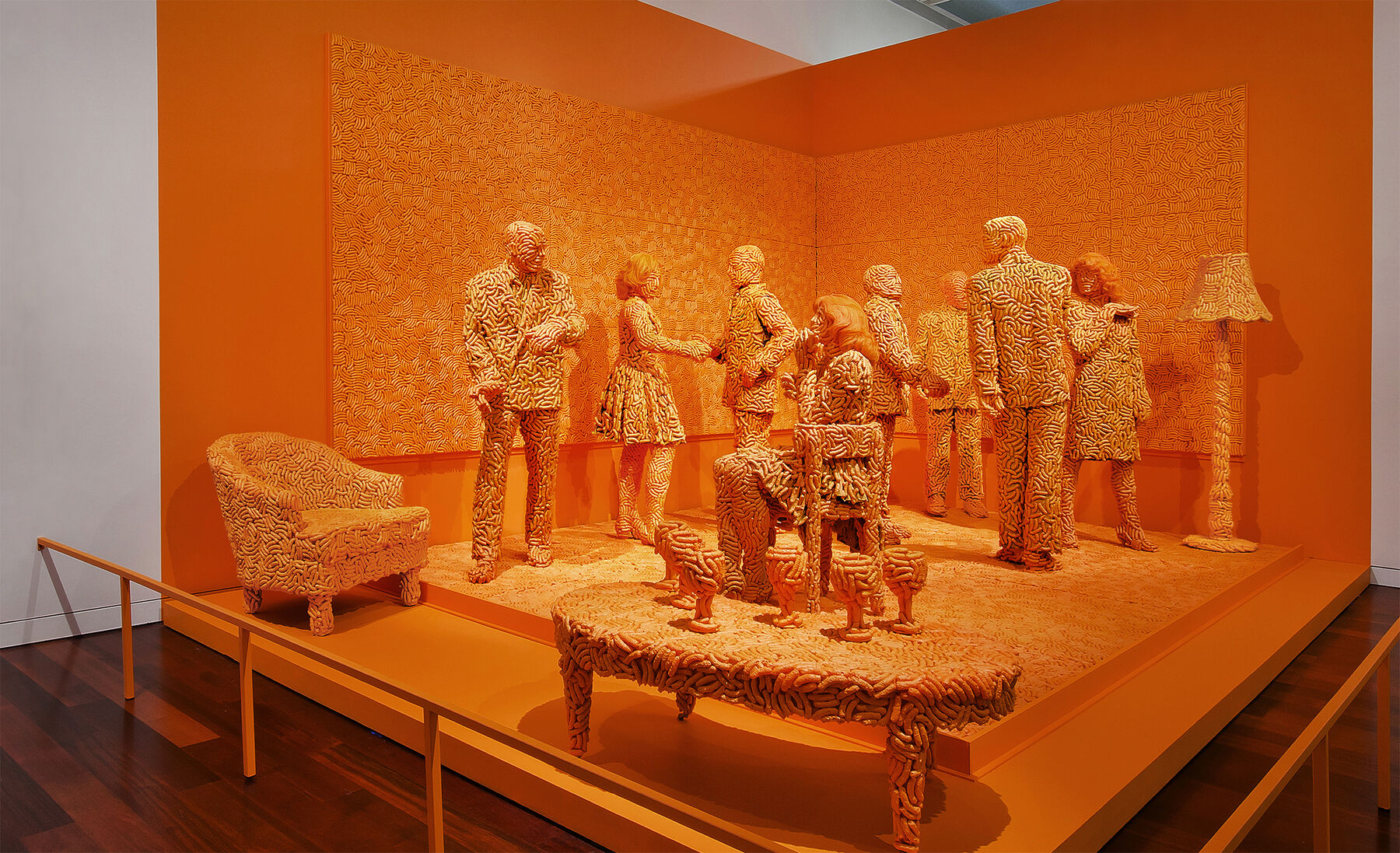 A display filled with figure sculptures talking among themselves and furniture that have been made by a snack called Cheez doodles