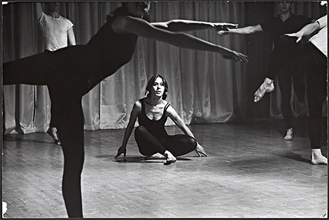 Photograph of Yvonne Rainer dancing in the "Bach" sectoin of Terrain, 1963